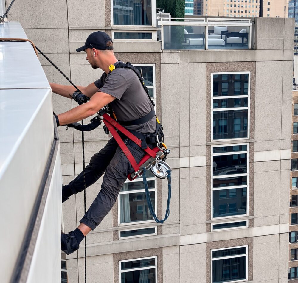 Rope access technician working on the Sofitel Hotel facade in New York