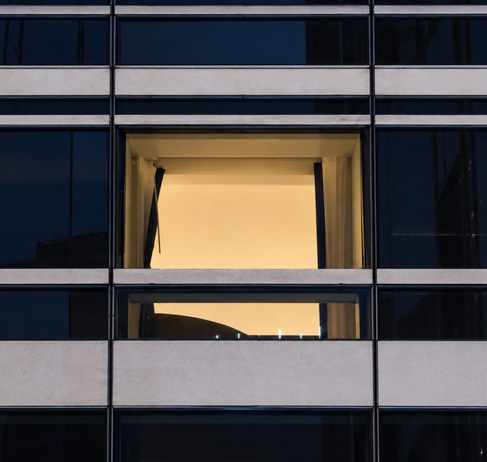 Hotel window opening during IGU replacement at dusk in Manhattan